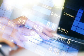 Double exposure of abstract creative statistics data hologram with hands typing on laptop on background, analytics and forecasting concept