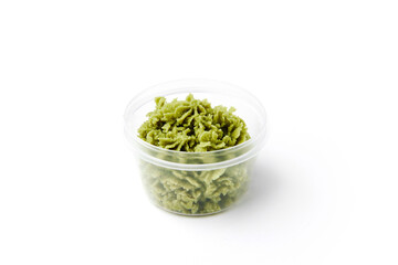 Green hot wasabi condiment in plastic jar isolated on white