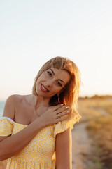 Happy mature woman feeling the breeze at beach. Beautiful middle aged woman on beach. Copy space.