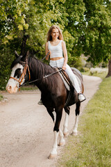 Fototapeta premium Beautiful girl with a horse for a walk