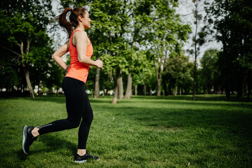 Woman jogging in the park in the morning