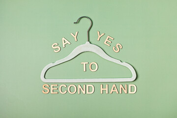 Rack with text say yes to second hand. Slow fashion; circular economy; eco friendly sustainable...