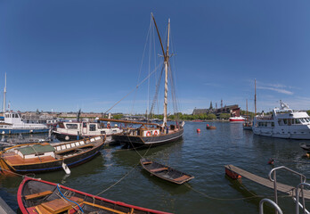 Fototapeta na wymiar Sail and transport boats at a pier a sunny day in Stockholm