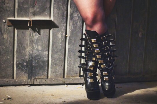 Close-up shot of gothic high leather boots with many straps and buckles