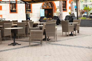 Empty restaurant summer terrace with tables and chairs.