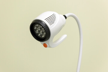Close-up medical lamp in the gynecologist's office. A mobile examination lamp in a doctor's or surgeon's office. Equipment for hospital or clinic. LED surgical light with flexible top.