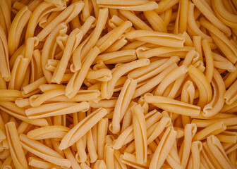uncooked dry Italian pasta strozzapreti background