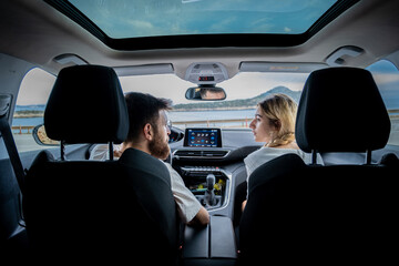 couple driving in beautiful cityscape