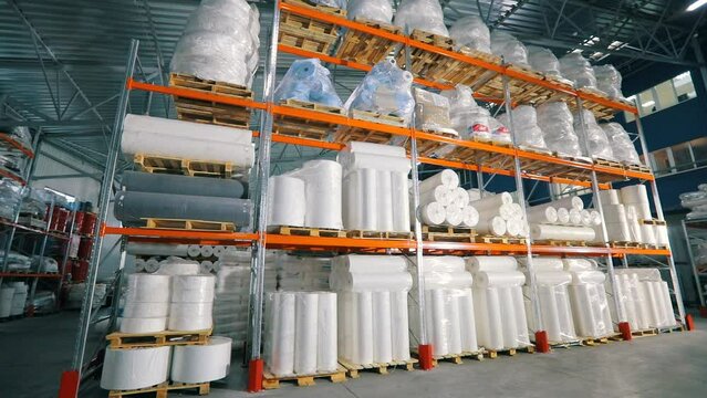 Lots of big rolls of spunbond. Warehouse with rolls of nonwovens. Large warehouse in the nonwovens factory. industrial interior