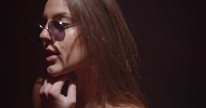 Cool girl with sunglasses dancing seductively