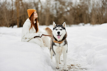 cheerful woman winter outdoors with a dog fun nature winter holidays