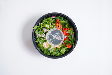 Vegetable salad in a disposable bowl. Food delivery.