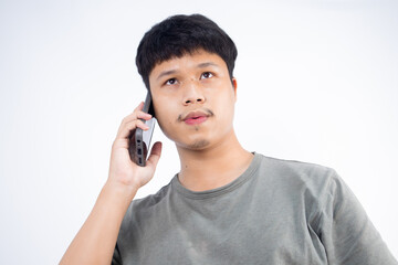 Asian man talking on the phone on a white background