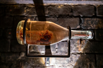 Sparkling wine production by traditional methods in underground cellars in Vienna, Austria. Sediment in bottle.