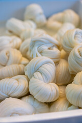 White soft braid cheese on market display