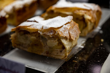 Austrian desserts, piece of apple strudel on display in traditional bakery cafe in Vienna.