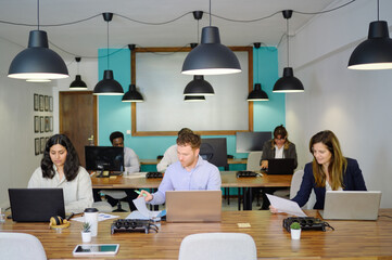 Company of multiethnic colleagues working in office