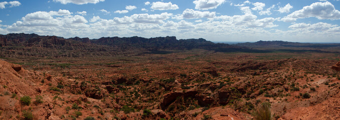 The red canyon. Panorama view of the arid desert, sandstone and rocky cliffs and mountains under a...