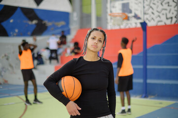 Self assured black female basketball player on sports ground