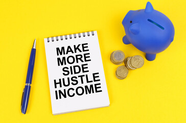 On a yellow surface, a piggy bank, coins and a notepad with the inscription - Make more side hustle...