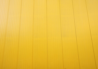 Yellow metal tile fence background. Fence from corrugated board. Yellow slate background. Yellow...
