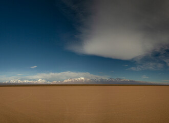 Panorama view of the arid desert in Barreal Blanco, in San Juan, Argentina. The Andes mountains in...