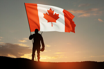 Canada army soldier with Canada flag on a background of sunset or sunrise. Greeting card for Poppy...