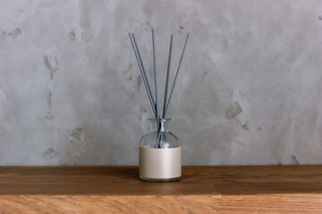 Aroma reed air freshener, home fragrance bottle with rattan sticks on a dark background. Diffuser...