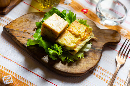 Flia served on lettuce salad leaf on wooden board, popular dish of Albanian and Kosovan cuisine