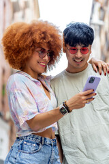 wedding couple smiling and looking with their smartphone