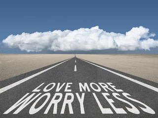 Love More Worry Less inspirational quote on highway background.