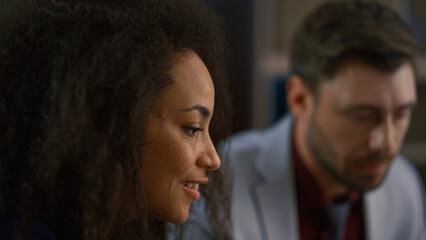 Multi ethnic business couple talking brainstorming ideas smiling in office cafe.