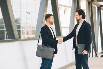 Two Businessmen Shaking Hands Outside Office