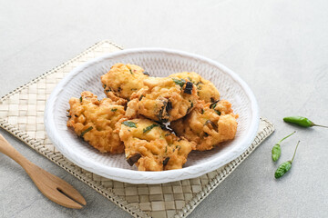 Perkedel Tahu, Made from mashed tofu, tapioca flour, spring onion, egg, salt and pepper. Served in white plate.
