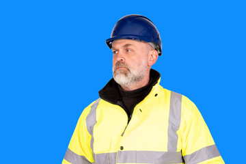 A construction worker in a blue hat and yellow hi-viz coat on blue background