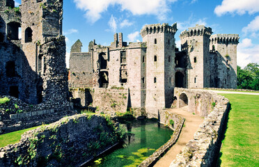 Raglan Castle near Monmouth in Gwent, east Wales, UK showing the moat, walls and entrance towers