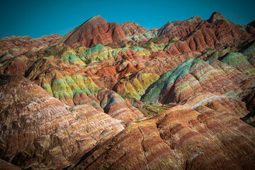 Red, green, yellow, orange layers of the Chinese rainbow mountains of Zhangye Danxia National Geological park, Gansu, China