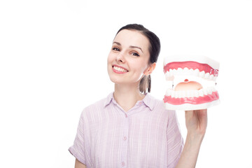 happy woman in a purple shirt holds a huge jaw mockup in her hand, white background