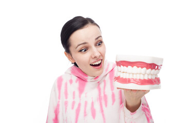 a woman in a pink hoodie looks in surprise at the jaw mock-up, white background