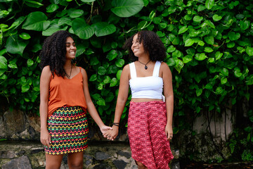 Happy lesbian couple holding hands in the park