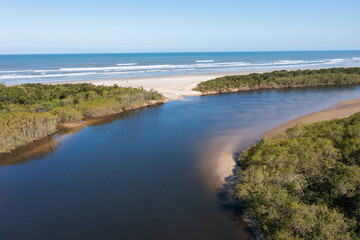 Aerial image of the meeting between Rio and the Sea. Environmental reserve, beautiful and empty beach