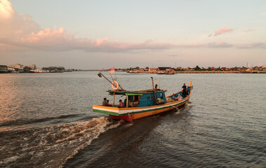 Naklejka na ściany i meble A boat sailing on Kapuas River, Pontianak