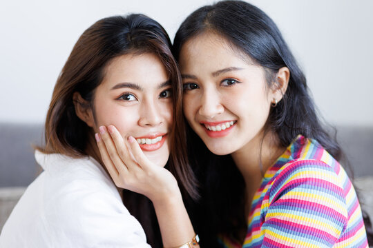 Asian lesbian couple, LGBT, Happy young cute Asia homosexual woman in bedroom at home, Cute girls smiling and looking at the camera, friendship LGPT lifestyle
