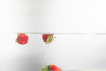strawberry dropping in water splash