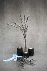 Willow twigs in a vase. A bouquet of willow. Flowers in a vase. Still-life. Candles. Candlesticks.