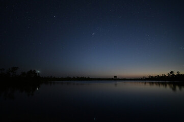 Fototapeta na wymiar Stars at twilight over Pine Glades Lake in Everglades National Park, Florida on clear April evening.