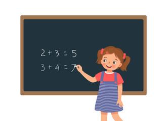 cute little girl student writing with chalk math equation solution on the blackboard in front of class 