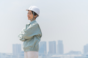 青空の中、ヘルメットを被った爽やかな日本人女性