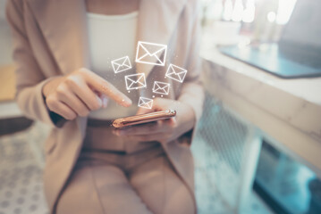 Email marketing concept. Woman using mobile smart phone sending online message with envelope icon