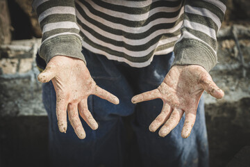 Stained hands are forced to work. The concept of anti-child labor. The abuse of labor. The...